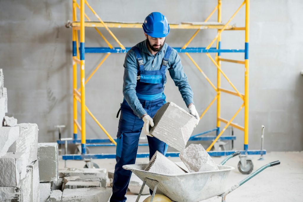 Builder working with blocks indoors